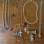Collection of vintage high school jewelry spread across a wooden nightstand